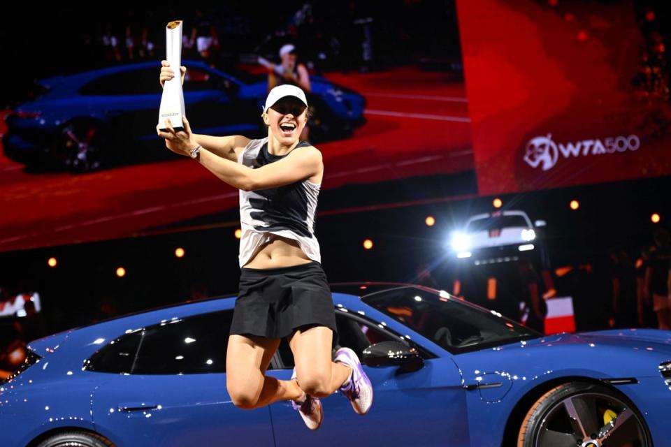 Iga Swiatek with the trophy and her new Porsche (Marijan Murat/dpa via AP) (AP)