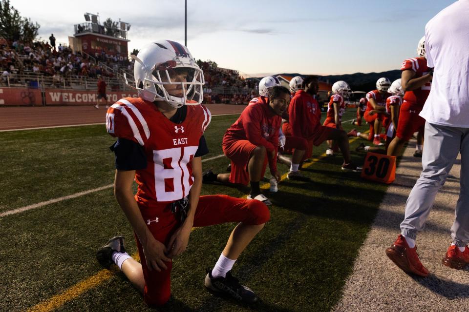 East players take a knee in their high school football season opener against Orem at East High School in Salt Lake City on Friday, Aug. 11, 2023. Despite East’s 14-0 lead at the end of the first half, Orem came back to win 21-20. | Megan Nielsen, Deseret News