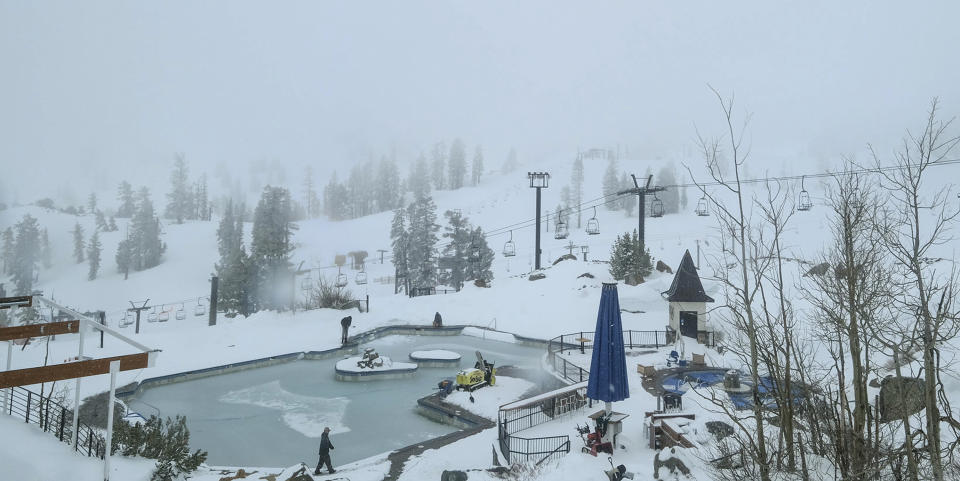 In this webcam image provided by Squaw Valley Alpine Meadows is the snow covered Squaw Valley High Camp Wednesday, May 22, 2019, in Olympic Valley, Calif. Memorial Day may be the unofficial start of summer, but California is heading toward the holiday with rainy, windy and snowy weather. The Squaw Valley resort at Lake Tahoe reports it got 32 inches of snow over the past seven days, boosting its season total to 714 inches. Unsettled weather will continue into next week. (Squaw Valley Alpine Meadows via AP)