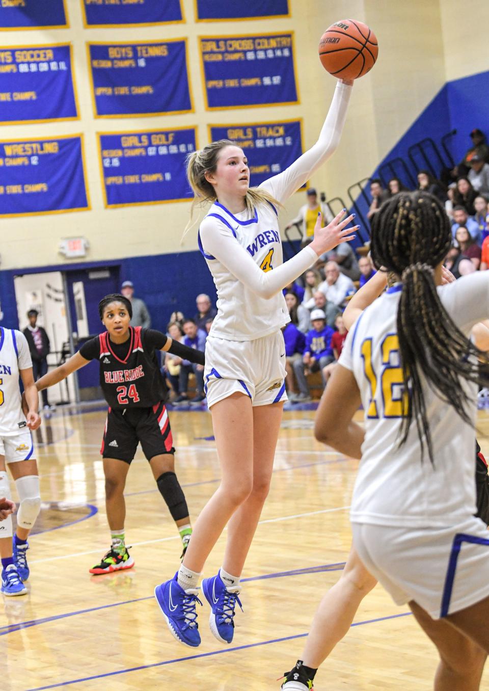 Wren junior Riley Stack (4) shoots the ball near Blue Ridge High senior Quadaija Langley during the third quarter  of the Class AAA State Playoffs at Wren High Saturday, February 19, 2022.