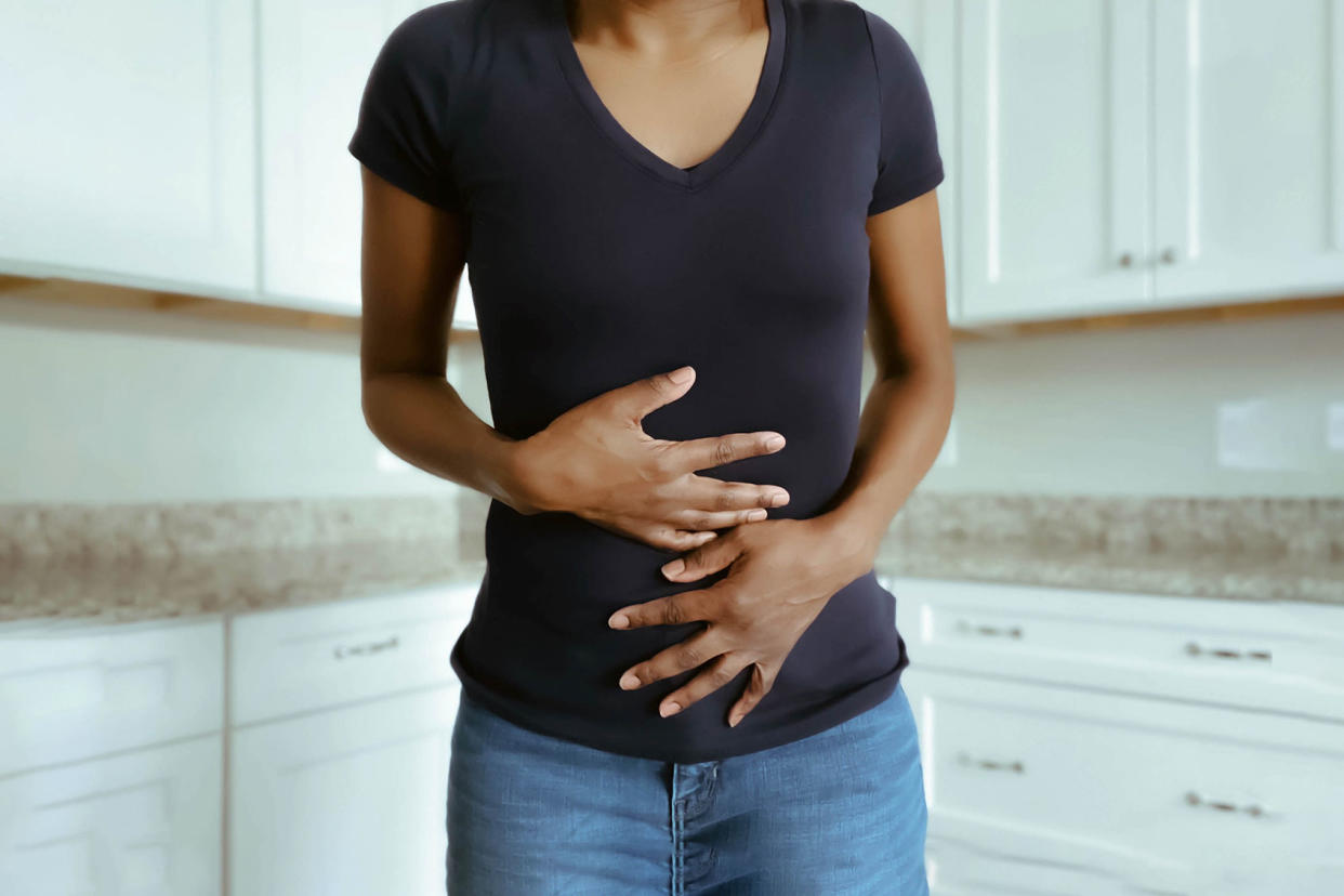 Woman Suffers Stomach Pains Getty Images/Grace Cary
