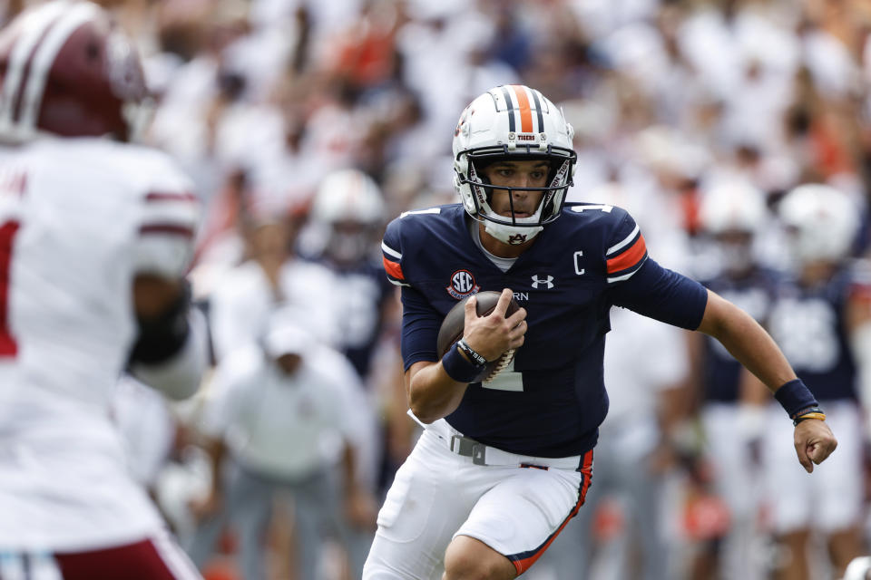 Auburn quarterback Payton Thorne (1) carries the ball during the first half of an NCAA college football game against Massachusetts Saturday, Sept. 2, 2023, in Auburn, Ala. (AP Photo/Butch Dill)