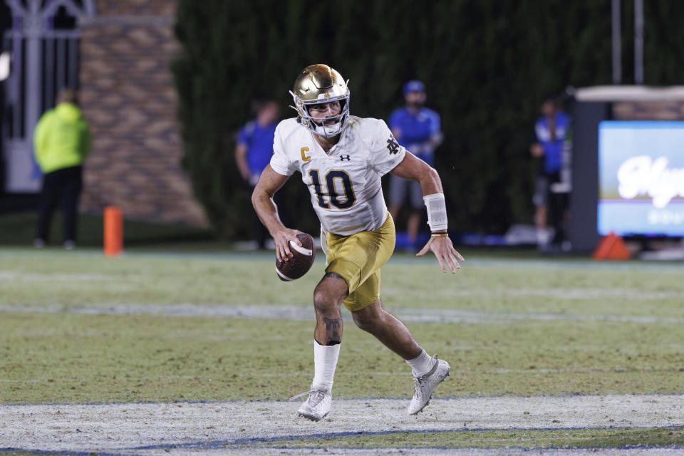 Notre Dame's Sam Hartman (10) scrambles during an NCAA college football game in Durham, N.C., Saturday, Sept. 30, 2023. (AP Photo/Ben McKeown)