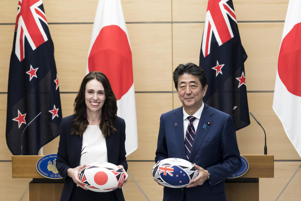 New Zealand's Prime Minister Jacinda Ardern, left, and Japan's Prime Minister Shinzo Abe hold rugby balls after a joint press conference following a meeting at Abe's official residence in Tokyo Thursday, Sept. 19, 2019. (Tomohiro Ohsumi/Pool Photo via AP)