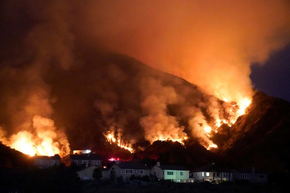 The Ranch Fire burns over a residential area in Azusa, California (AP)