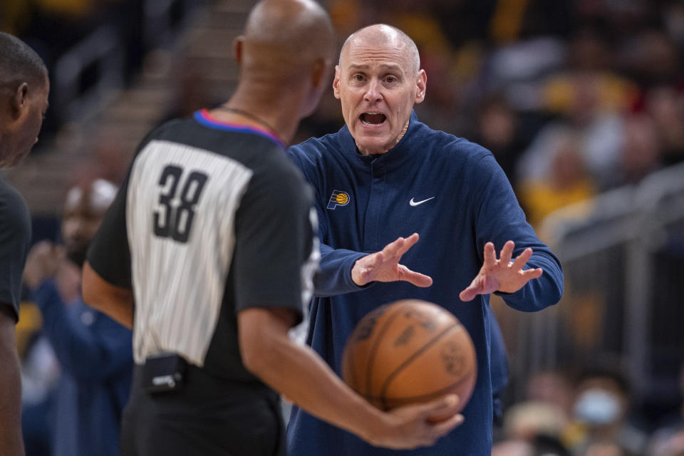 Indiana Pacers coach Rick Carlisle talks with an official during the first half of the team's NBA basketball game against the Miami Heat in Indianapolis, Saturday, Oct. 23, 2021. (AP Photo/Doug McSchooler)