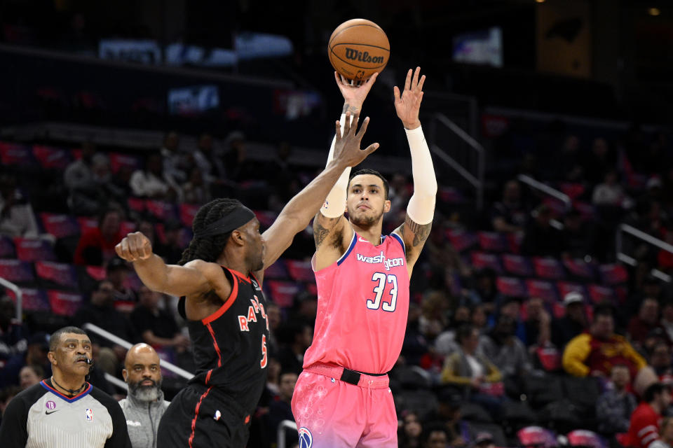 Washington Wizards forward Kyle Kuzma (33) shoots against Toronto Raptors forward Precious Achiuwa (5) during the first half of an NBA basketball game, Thursday, March 2, 2023, in Washington. (AP Photo/Nick Wass)