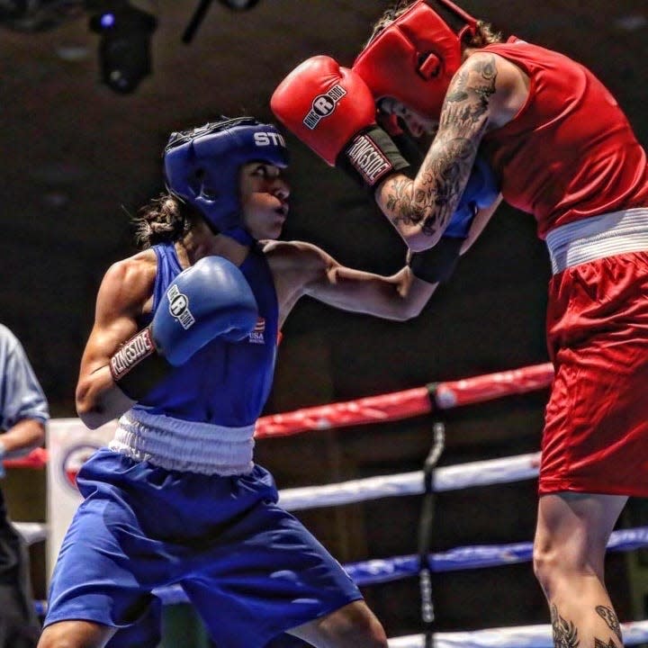 Donarie Nuñez in blue fights during the Upper Midwest Golden Gloves tournament.