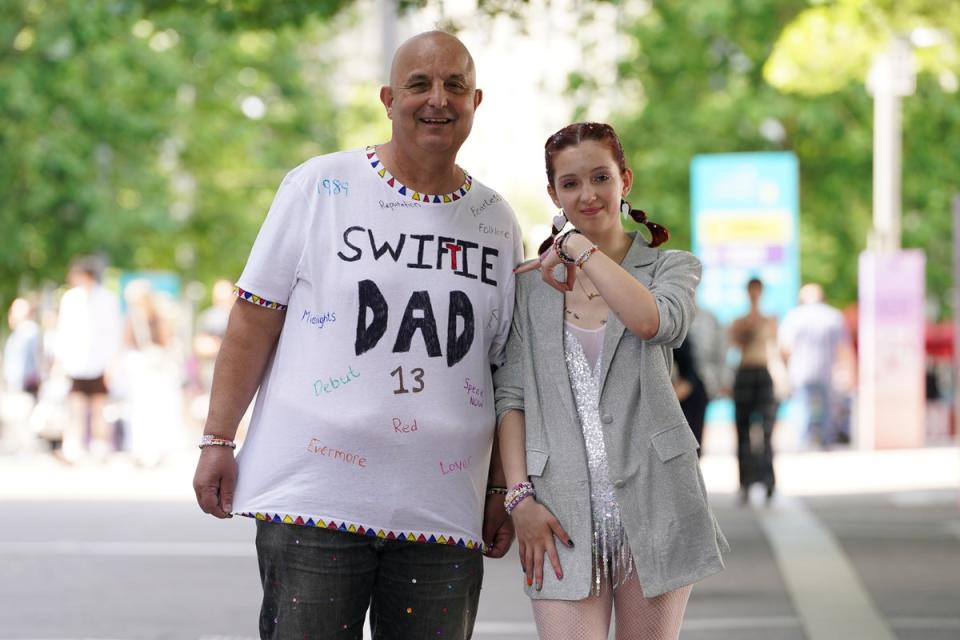 A Swiftie and her Swifty Dad wait outside Wembley Stadium in London (Lucy North/PA Wire)
