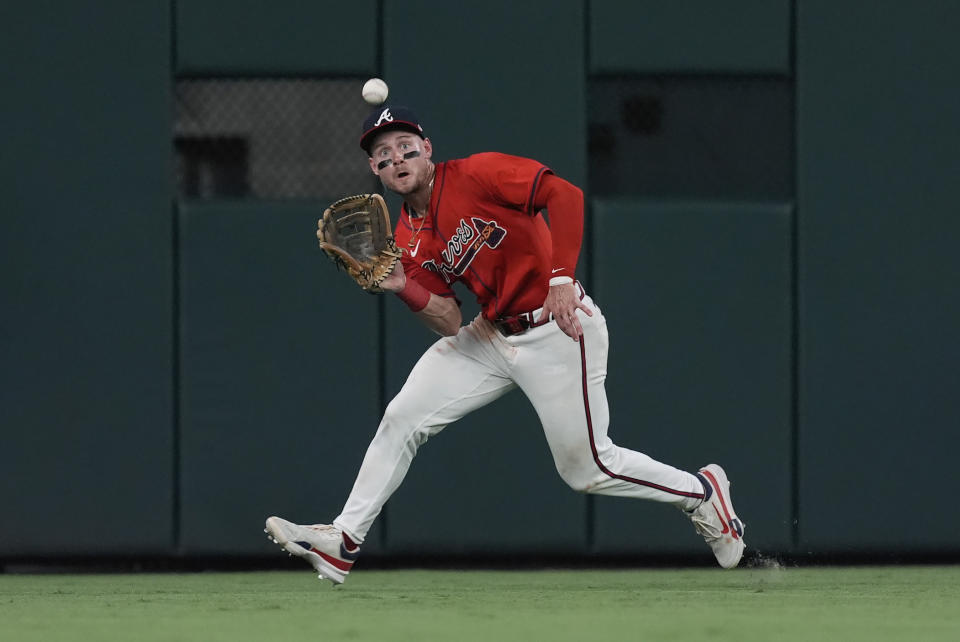 Atlanta Braves centerfielder Jarred Kelenic catches a flyball off the bat of Pittsburgh Pirates' Edward Olivares in the sev enth inning of a baseball game Friday, June 28, 2024, in Atlanta. (AP Photo/John Bazemore)