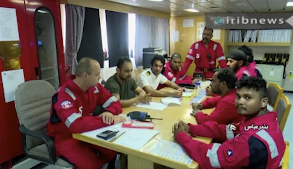 In this photo released by state-run IRIB News Agency, which aired on Monday, July 22, 2019, shows various crew members of the British-flagged tanker Stena Impero, that was seized by Tehran in the Strait of Hormuz on Friday, during a meeting. The Associated Press cannot independently verify the condition of the crew members, but in the video they looked to be in good health and it didn't appear as though they were being filmed under duress. (IRIB News Agency via AP)