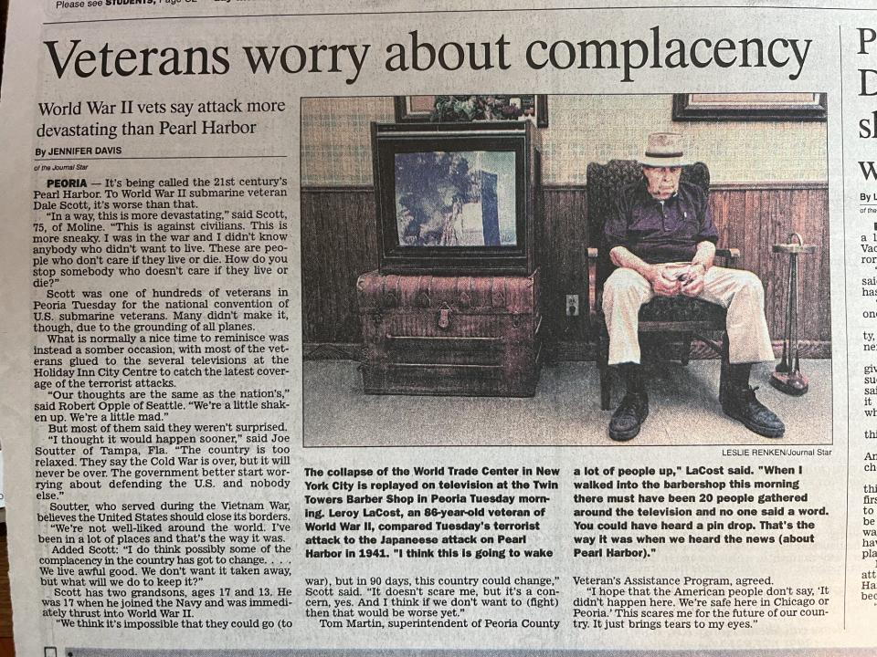 On Sept. 11, 2001, Leroy LaCost, an 86-year-old veteran of World War II, sits by a television in the barbershop in Peoria's Twin Towers Mall as the scene of the falling Twin Towers in New York City is played on the news.