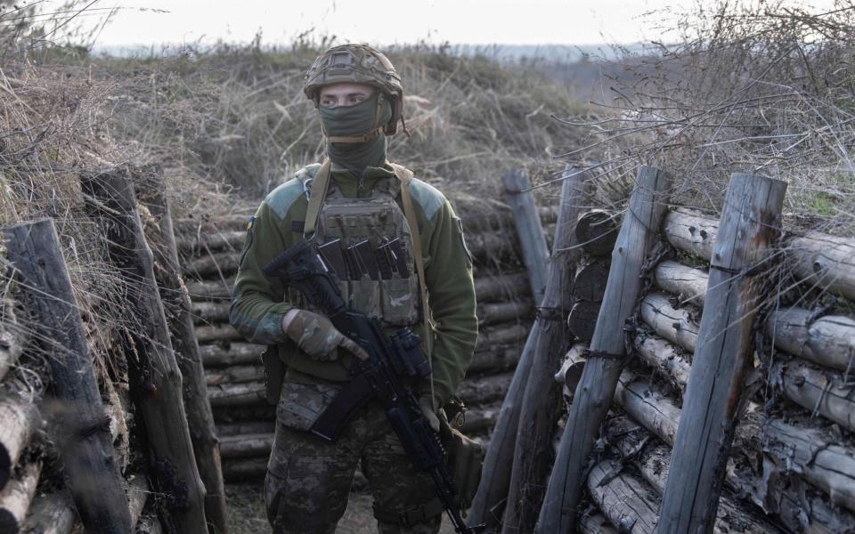 Ukrainian troops move through trenches along the frontline near Shchastaya, Eastern Ukraine - Julian Simmonds