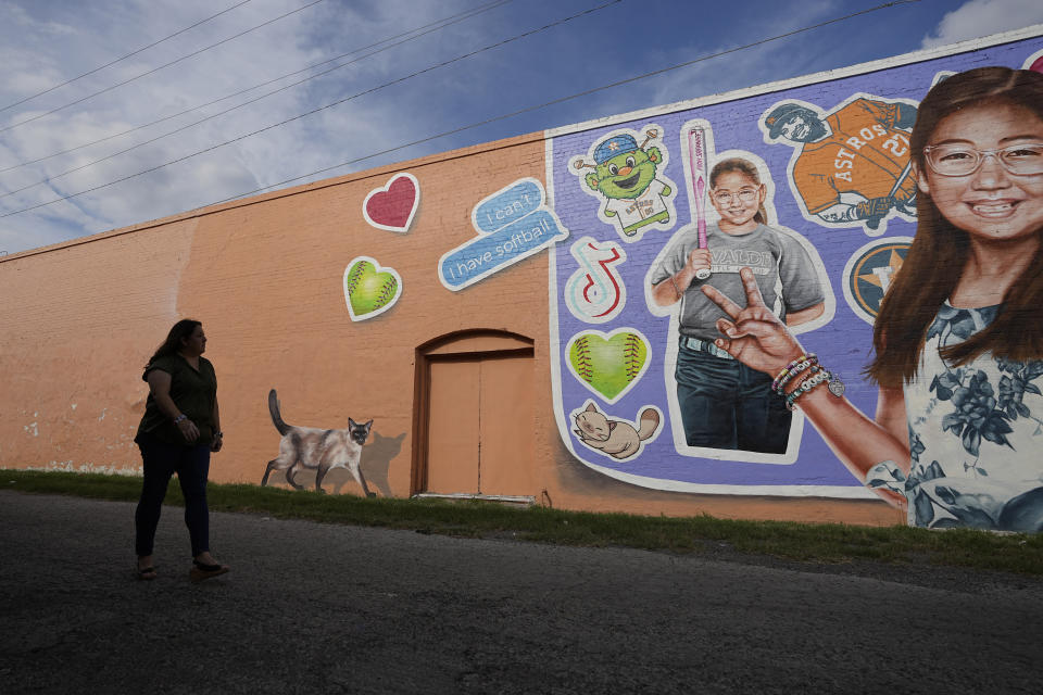 Veronica Mata visits a mural honoring her daughter, Tess, in Uvalde, Texas, Wednesday, May 3, 2023. For Mata, teaching kindergarten in Uvalde after her daughter was among the 19 students who were fatally shot at Robb Elementary School became a year of grieving for her own child while trying to keep 20 others safe. (AP Photo/Eric Gay)