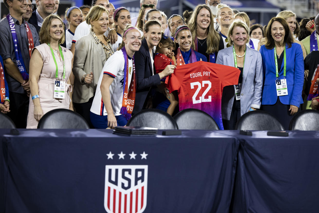 Members of U.S. Soccer and the USWNT Players Association hold up an Equal Pay jersey after signing a collective bargaining agreement signifying equal pay between the men's and women's national soccer teams on Sept. 6, 2022, at Audi Field in Washington, D.C. (Photo by Ira L. Black - Corbis/Getty Images)