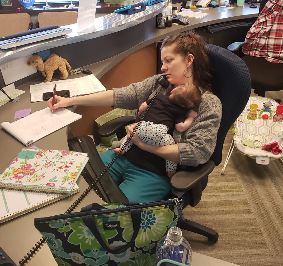 Melody Blackwell brings her baby to work once a week, and works from home the other four days. Her boss, who suggested the schedule, snapped this photo in December. (Photo: Dr. Elizabeth Baker via Facebook)