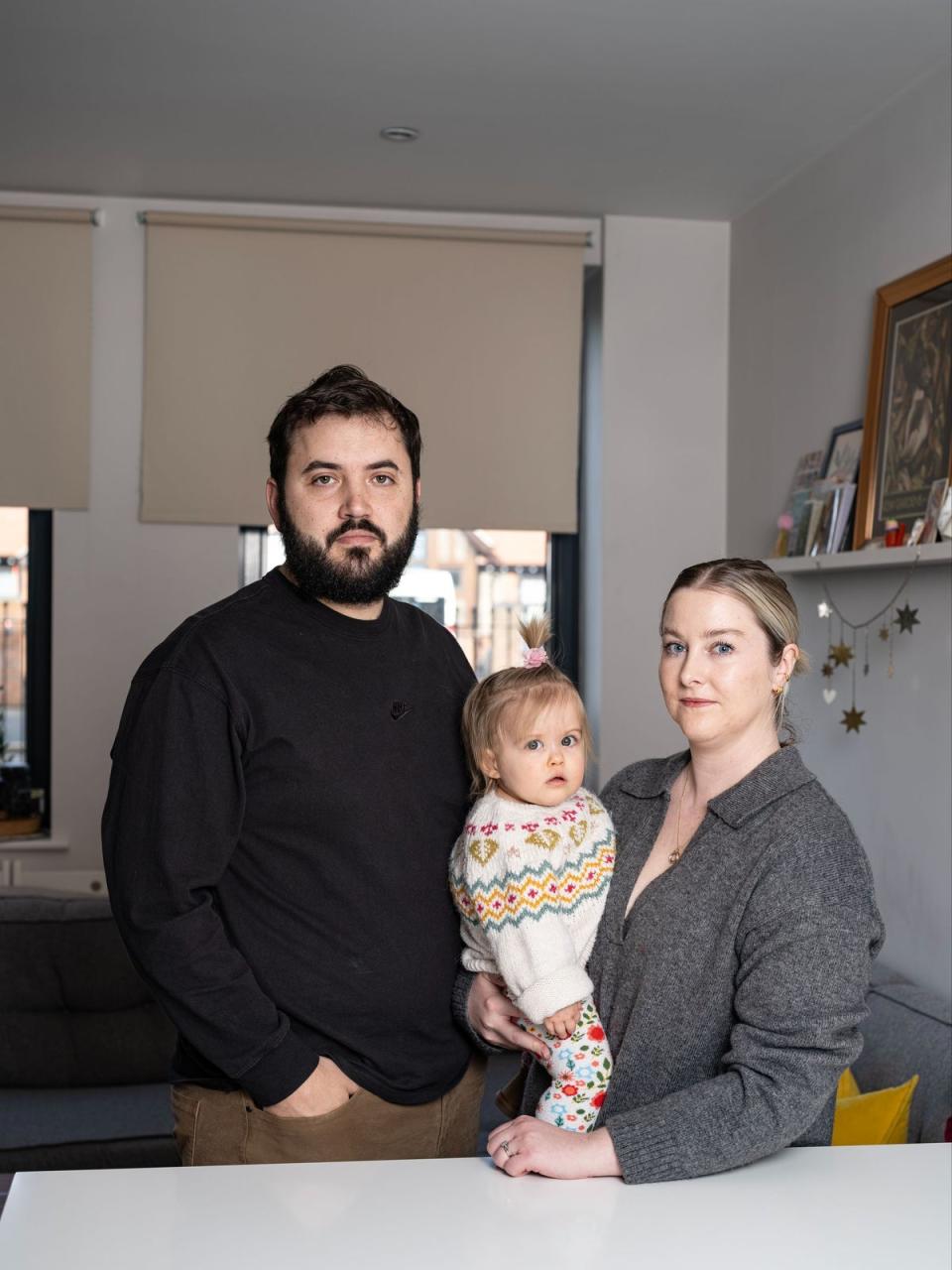 Rob Jenkins with his baby Maeve and partner Katie James who are owners of a property in development John Busch House In Isleworth which has cladding associated with the fire safety scandal (Daniel Hambury/Stella Pictures Ltd)