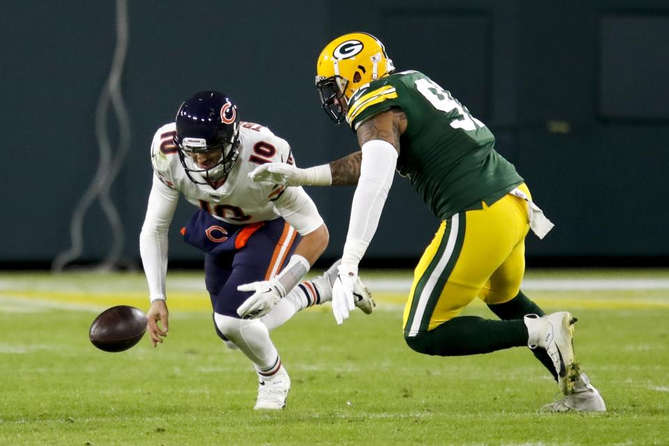 Chicago Bears' Mitchell Trubisky recovers his own fumble in front of Green Bay Packers' Preston Smith during the second half of an NFL football game Sunday, Nov. 29, 2020, in Green Bay, Wis. (AP Photo/Matt Ludtke)
