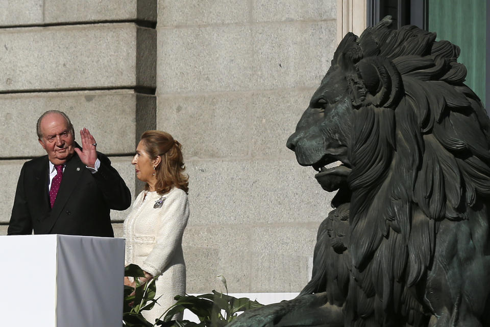 Spain's former King Juan Carlos waves to the crowd next to Spain's parliament speaker Ana Pastor after celebrations of the 40th anniversary of the Spanish Constitution at the Spanish parliament, in Madrid, Spain, on Thursday, Dec. 6, 2018. (AP Photo/Andrea Comas)