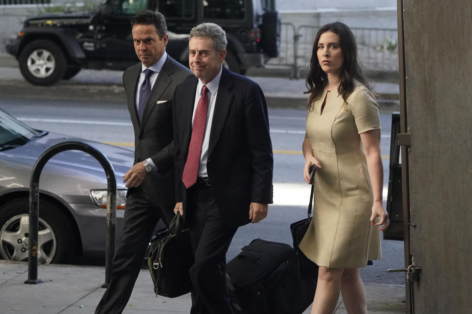 Attorneys Alan Jackson, left, Mark Werksman, center, and Jacqueline Sparagna, representing Harvey Weinstein, arrive at the Los Angeles County Superior Court Monday, Oct. 24, 2022, in Los Angeles. A jury of nine men and three women has been selected in the Los Angeles rape and sexual assault trial of Harvey Weinstein, and opening statements are set to start Monday. (AP Photo/Marcio Jose Sanchez)