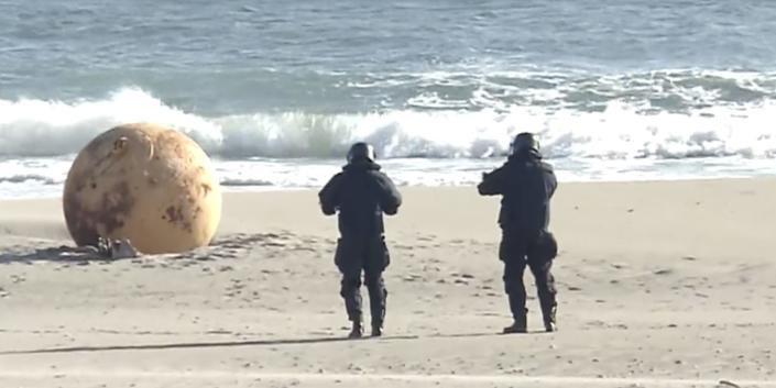 Japan is mystified by a giant metal sphere that washed up on a beach. An  expert said the ball isn't a 'Godzilla egg,' but just a buoy.