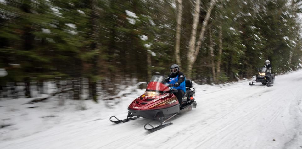 Snowmobilers ride a trail Thursday, December 29, 2022 in the Pelican River Forest between Rhinelander and Crandon, Wis. It is bisected by Highway 8 east of Rhinelander and straddles the Great Lakes and Mississippi River watersheds.In October, the Wisconsin Natural Resources Board signed off on a $15.5 million conservation easement for more than 56,000 acres in northern Wisconsin.It is the largest land conservation effort in state history. It will secure permanent access for public recreation, continue timber management and keep the tract free from development.