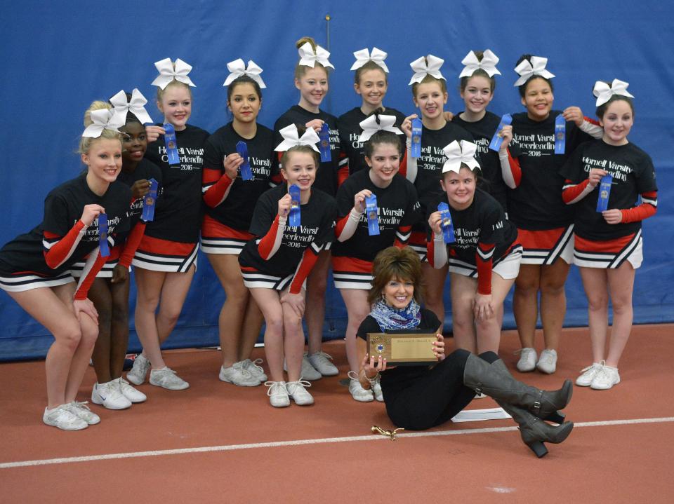 Regi Gambino sits with the Section V title after Hornell cheerleading was crowned with the championship during Gambino's coaching tenure. Gambino was also named Coach of the Year.