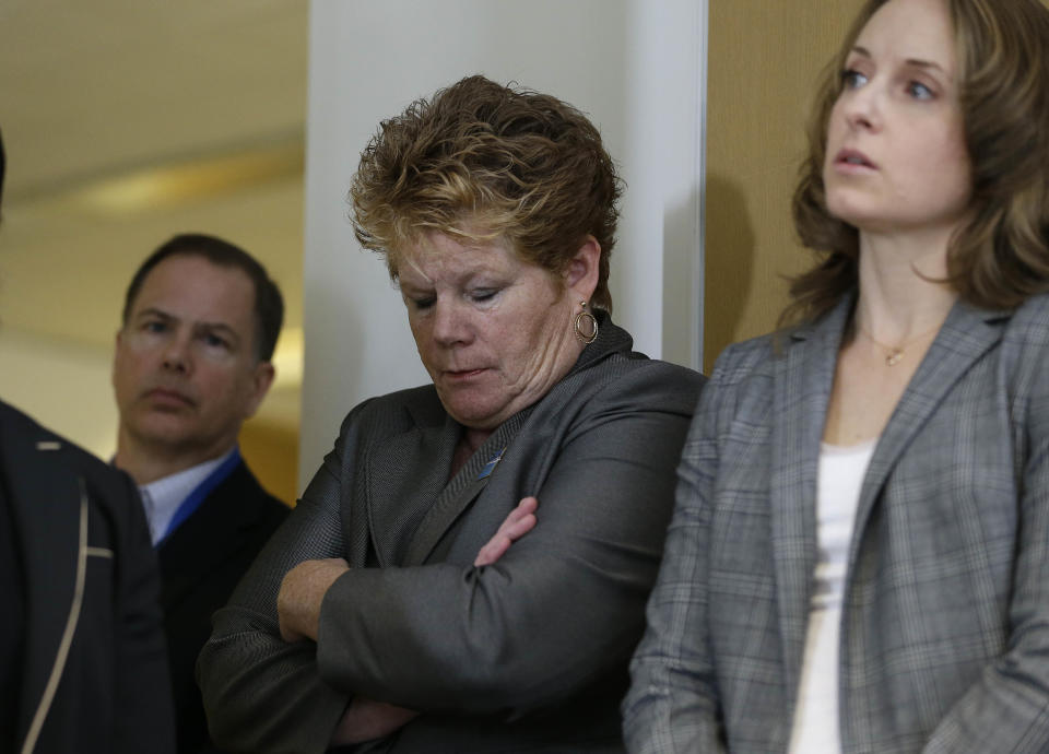 Bay Area Rapid Transit general manager Grace Crunican, center, listens as BART police chief Kenton Rainey talks about the shooting of a BART officer who was killed by a fellow officer during a news conference Wednesday, Jan. 22, 2014, in Oakland, Calif. Authorities say a San Francisco Bay Area public transit officer who was shot and killed Tuesday by a fellow officer while searching an apartment was looking for a laptop and other stolen items. Rainey declined to disclose any further details of how the shooting of Sgt. Tom Smith occurred. A robbery suspect was in custody. (AP Photo/Eric Risberg)