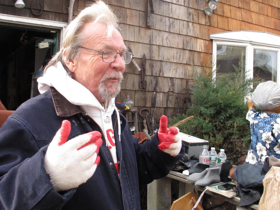 In this Friday, Nov. 16, 2012 photo, artist Kenny Goodman describes the damage from Superstorm Sandy inside his shop in the Fire Island community of Ocean Beach, N.Y. (AP Photo/Frank Eltman)