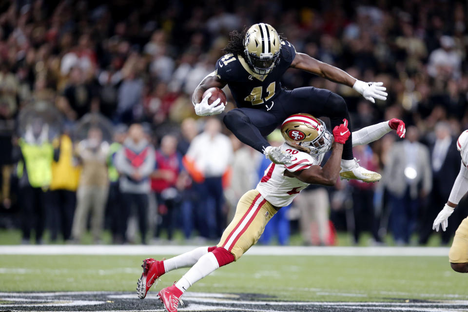 New Orleans Saints running back Alvin Kamara (41) hurdles over San Francisco 49ers free safety Jimmie Ward (20) in the first half an NFL football game in New Orleans, Sunday, Dec. 8, 2019. (AP Photo/Brett Duke)