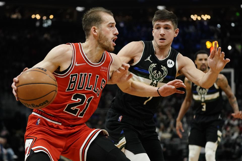 Chicago Bulls' Matt Thomas tries to get past Milwaukee Bucks' Grayson Allen during the first half of an NBA basketball game Friday, Jan. 21, 2022, in Milwaukee. (AP Photo/Morry Gash)