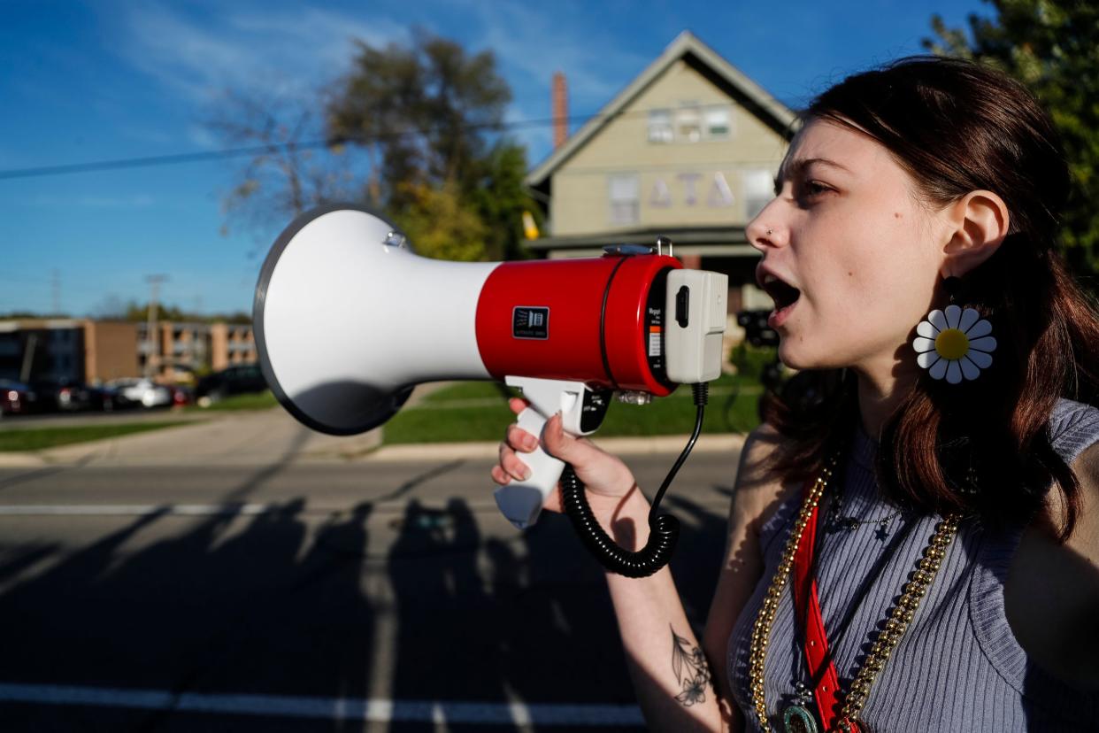 EMU freshmen Lynn Green speaks outside of fraternity Delta Tau Delta during a protest against the fraternities in the center of a sexual assault report in Ypsilanti on Oct. 19, 2021.