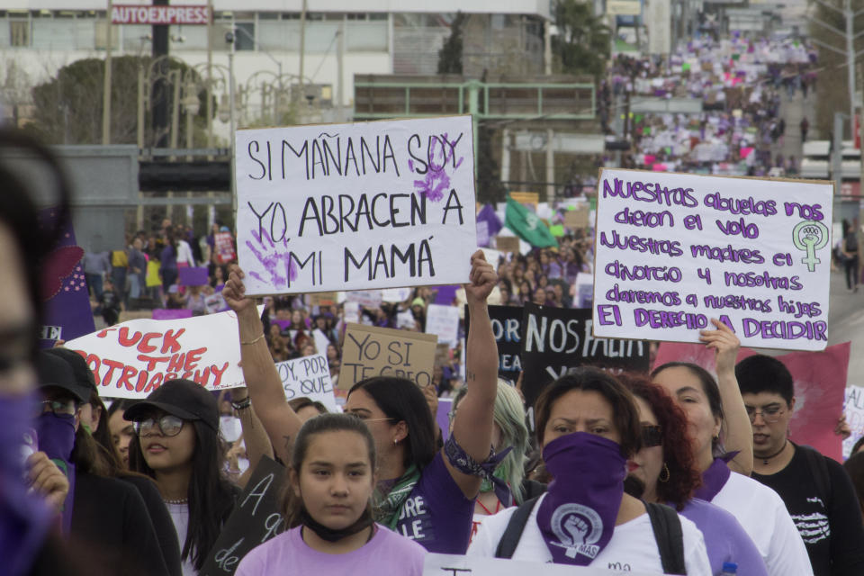 Women hold signs against gender-based violence and in favor of abortion on International Women's Day, in Chihuahua, Mexico, Wednesday, March 8, 2023. A network of abortion-rights activists in Mexico is finding ways to offer assistance -- including shipments of abortion pills -- to women in the United States affected by recently imposed abortion bans in several states. (AP Photo/Adriana Esquivel)