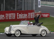 Mercedes driver Lewis Hamilton, of Britain, flashes a victory sign during the opening parade of the Formula One Mexico Grand Prix auto race at the Hermanos Rodriguez racetrack in Mexico City, Sunday, Oct. 27, 2019. (AP Photo/Eduardo Verdugo)