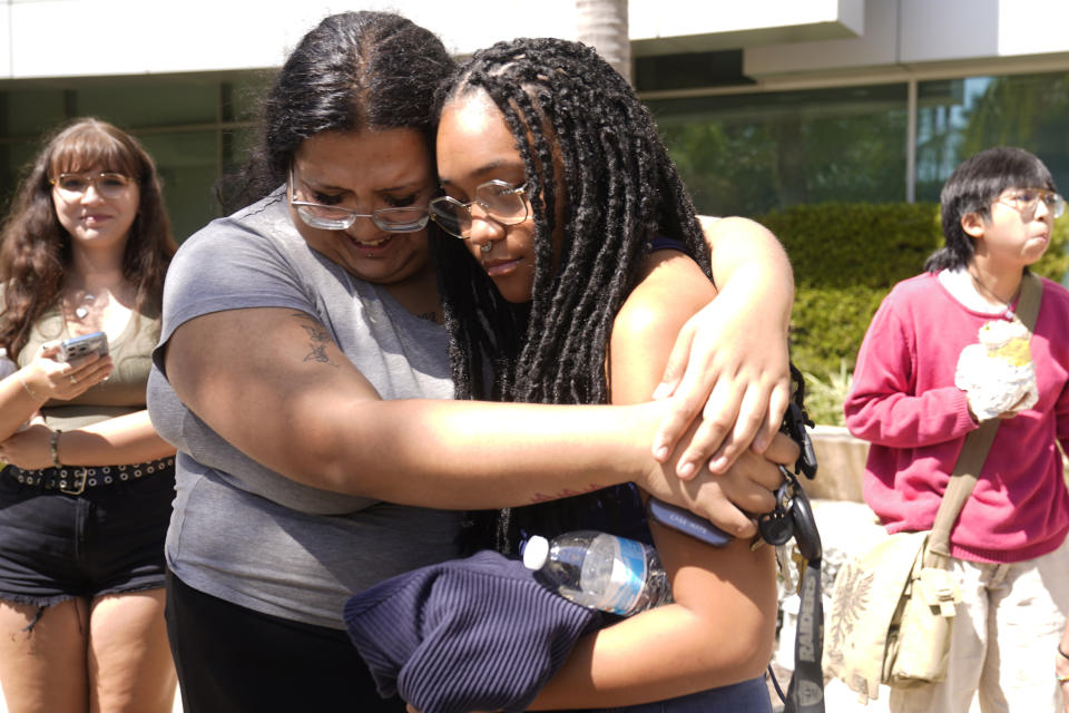 CSU Long Beach Sociology student Jennifer Chavez, left, hugs CSU Channel Islands Business student Angelmarie Taylor after the California State University Board of Trustees passes a motion to increase tuition fees at the California State University chancellor's office, Wednesday, Sept. 13, 2023, in Long Beach, Calif. The California State University's Board of Trustees on Wednesday planned to vote on a tuition hike for students. Their proposal would raise tuition by 6% each year for five years. (AP Photo/Damian Dovarganes)