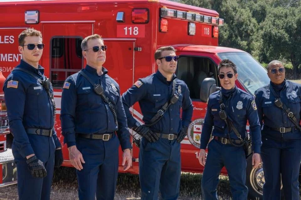 9-1-1 characters Buck, Bobby, Eddie, Chim and Hen stand in front of a paramedic truck