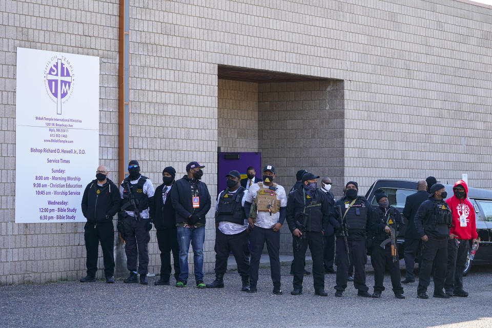 Members of Minnesota Freedom Fighters gather around the hears carrying Daunte Wright's casket at Shiloh Temple International Ministries in Minneapolis, Thursday, April 22, 2021. The 20-year-old Wright was killed by then-Brooklyn Center police officer Kim Potter during a traffic stop on April 11. (AP Photo/Julio Cortez)