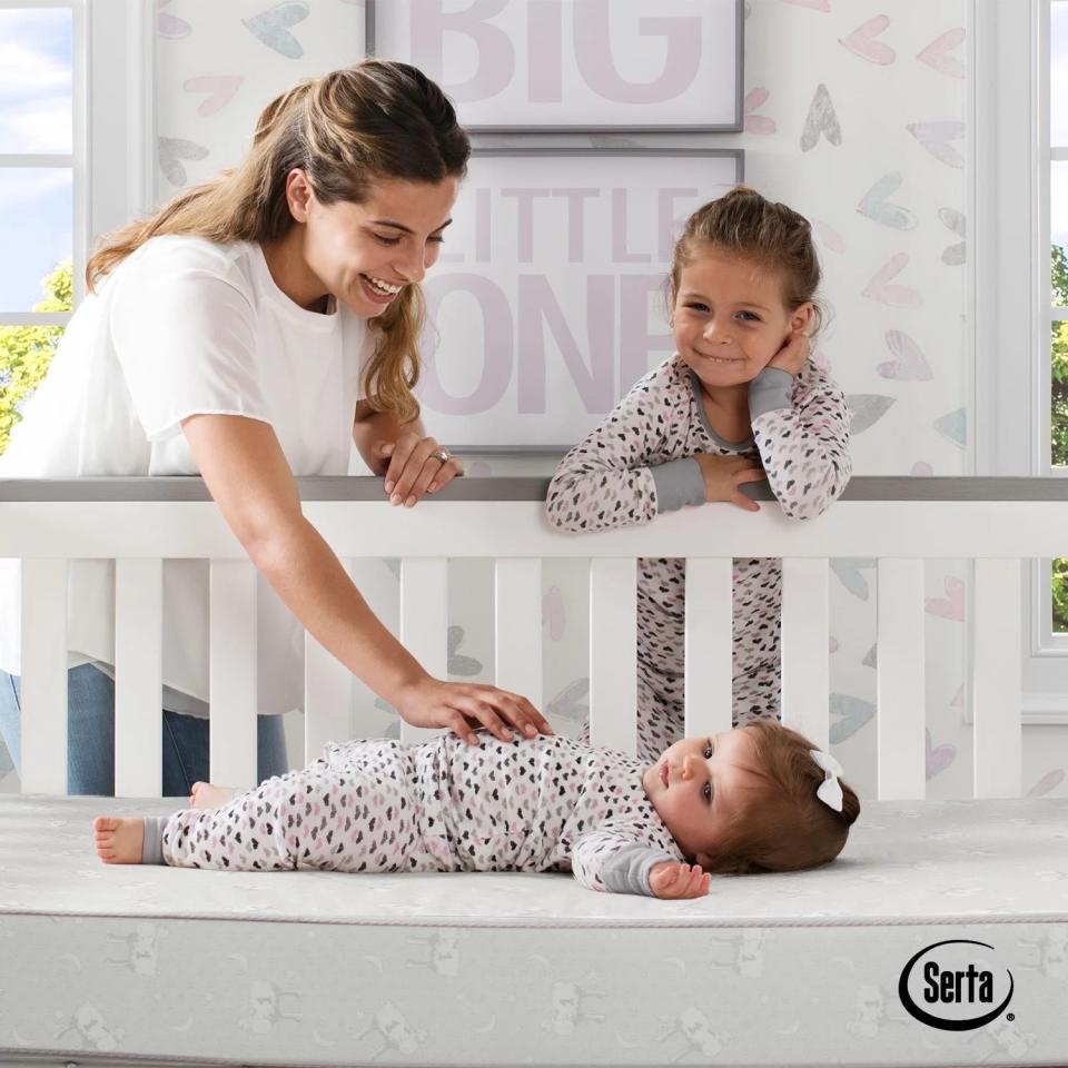 An infant lying on the mattress to show its thickness