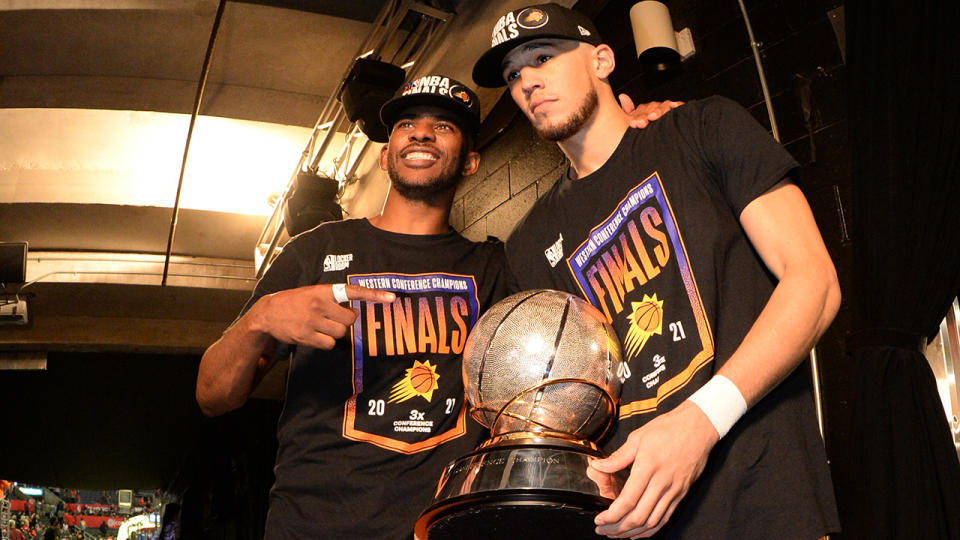 Chris Paul and Devin Booker celebrate after the Phoenix Suns defeated the LA Clippers in the NBA's Western Conference Finals. (Photo by Andrew D. Bernstein/NBAE via Getty Images)