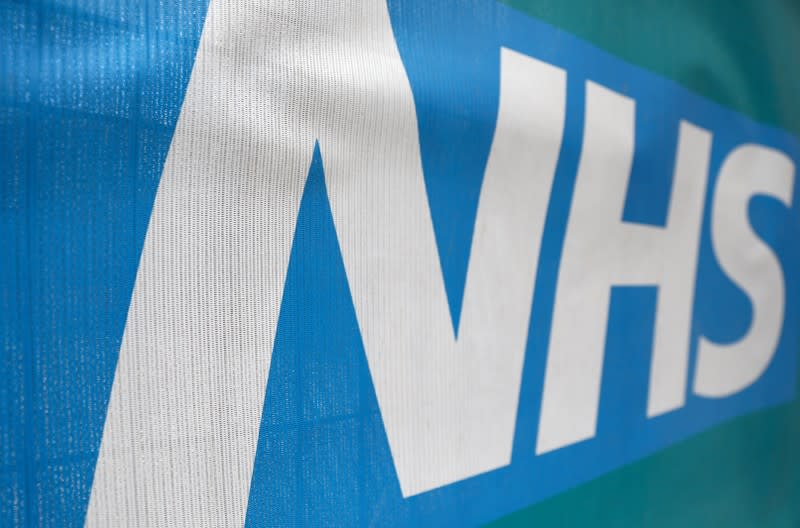 FILE PHOTO: An NHS logo is displayed outside a hospital in London