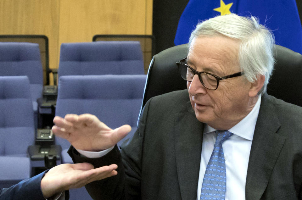 European Commission President Jean-Claude Juncker, right, is greeted by European Commission Secretary General Martin Selmayr during a meeting of the College of Commissioners at EU headquarters in Brussels, Wednesday, May 15, 2019. (AP Photo/Virginia Mayo)