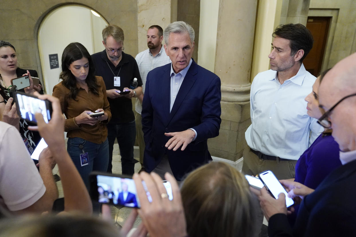 Speaker of the House Kevin McCarthy, R-Calif., speaks with members of the press after participating in a phone call on the debt ceiling with President Joe Biden, Sunday, May 21, 2023, on Capitol Hill in Washington. Standing at right with McCarthy is Rep. Garret Graves, R-La., McCarthy's top mediator in the debt limit talks. (AP Photo/Patrick Semansky)