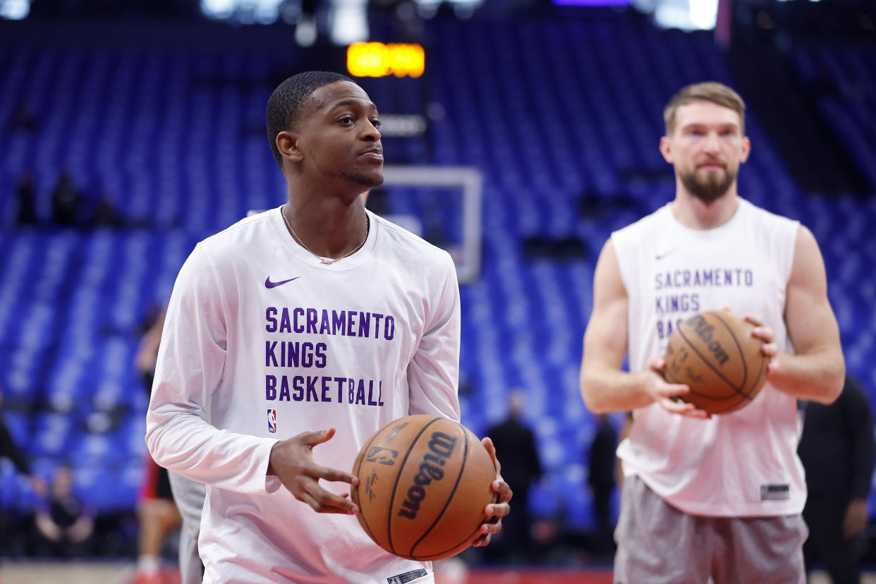 SACRAMENTO, CALIFORNIA - APRIL 14: De'Aaron Fox #5 and Domantas Sabonis #10 of the Sacramento Kings warms up before the game against the Portland Trail Blazers at Golden 1 Center on April 14, 2024 in Sacramento, California. NOTE TO USER: User expressly acknowledges and agrees that, by downloading and or using this photograph, User is consenting to the terms and conditions of the Getty Images License Agreement. (Photo by Lachlan Cunningham/Getty Images)