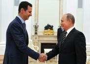 Syrian leader Bashar al-Assad (left) travelled to Moscow for talks with his Russian counterpart Vladimir Putin in October 2015