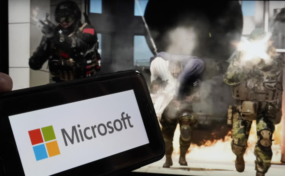 The logo for Microsoft, and a scene from Activision "Call of Duty - Modern Warfare," are shown in this photo, in New York, Wednesday, June 21, 2023. Microsoft on Thursday will try to gain clearance to complete a $69 billion takeover of video game maker Activision Blizzard in a legal showdown with U.S. regulators that will reshape a pastime that's bigger than the movie and music industries combined. (AP Photo/Richard Drew)