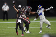 Tampa Bay Buccaneers quarterback Tom Brady (12) throws a pass as offensive tackle Tristan Wirfs (78) blocks Los Angeles Rams outside linebacker Leonard Floyd (54) during the first half of an NFL football game Monday, Nov. 23, 2020, in Tampa, Fla. (AP Photo/Jason Behnken)