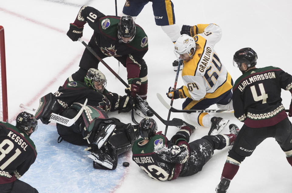 Nashville Predators' Mikael Granlund (64) is stopped by Arizona Coyotes goalie Darcy Kuemper (35) during overtime in an NHL hockey playoff game Friday, Aug. 7, 2020, in Edmonton, Alberta. (Jason Franson/Canadian Press via AP)