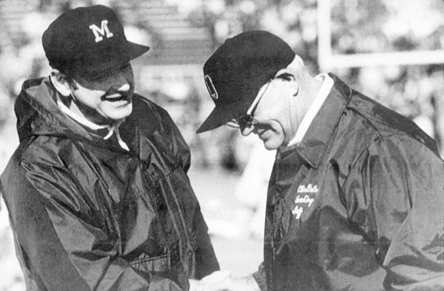 FILE – Michigan coach Bo Schembechler, left, meets with Ohio State coach Woody Hayes at an NCAA college football game. Woody and Bo were kindred spirits as they clashed during the 1970s in what became known as the 10-year Year War between Ohio State and Michigan. The mutual respect that has been a pillar of what is arguably college football’s greatest rivalry appears to be lacking these days — even among the coaches.(AP Photo/File)