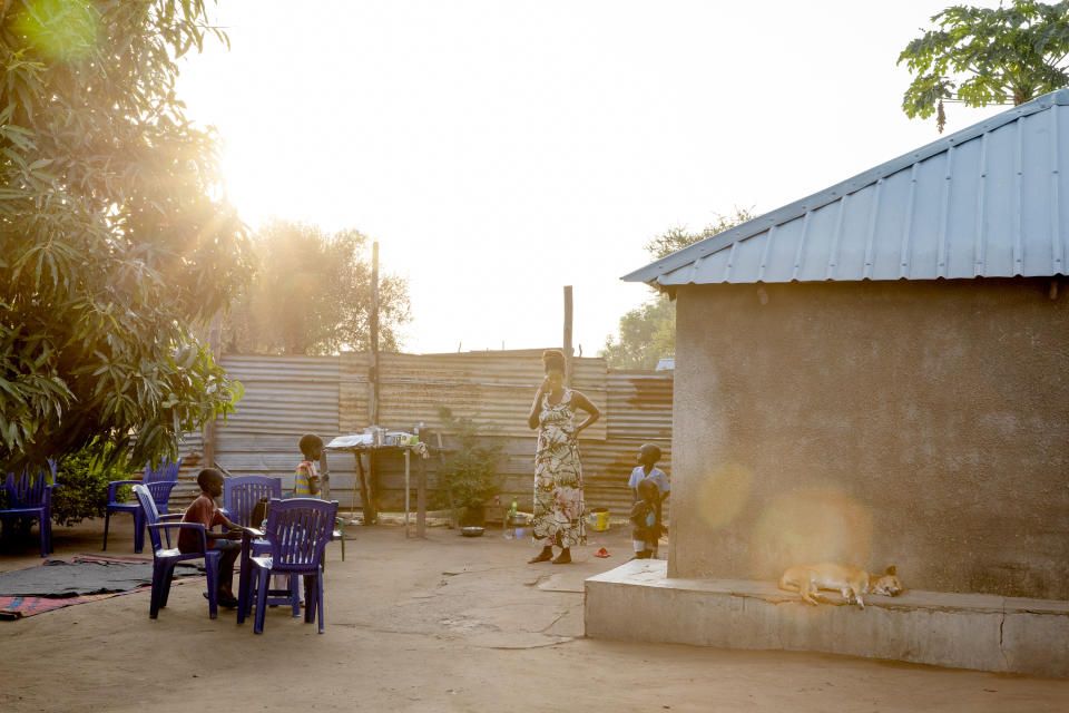 Paska Itwari Beda, the young mother of five children, is on the phone at her Juba, South Sudan home, Wednesday, May 26, 2021. Even before the pandemic hit, South Sudanese women were accustomed to building lives on the edge of uncertainty. But COVID-19 is shaking that fragile foundation. The country is just a decade old and one of the world's most difficult places to raise children. (AP Photo/Adrienne Surprenant)