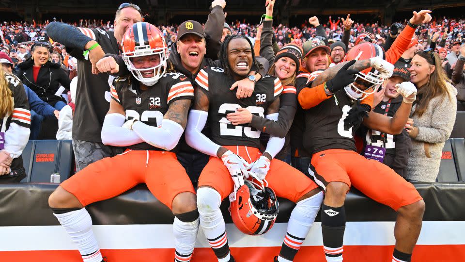 Ronnie Hickman, Martin Emerson Jr. and Greg Newsome II of the Cleveland Browns celebrate with fans after beating the Pittsburgh Steelers. - Jason Miller/Getty Images